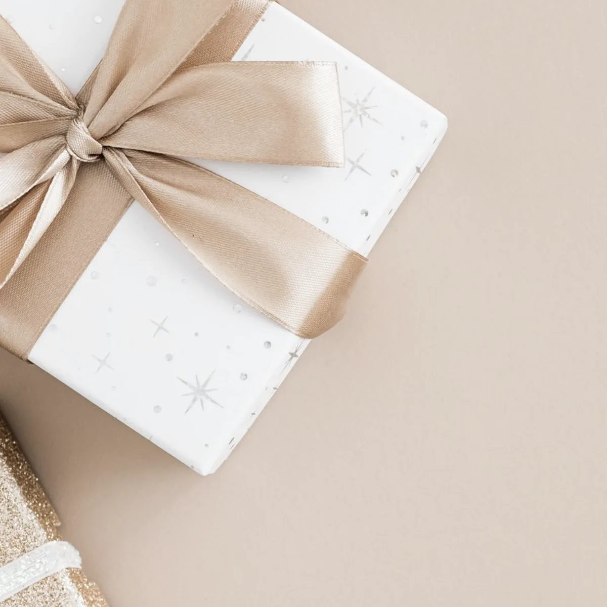 A wrapped gift box with a soft satin bow
